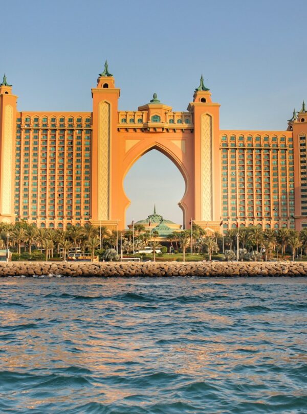 a very tall building sitting on top of a body of water