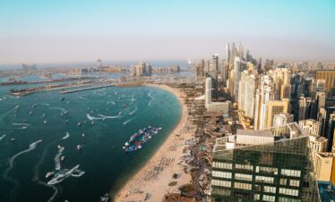Dubai's coastline and cityscape from an aerial view.