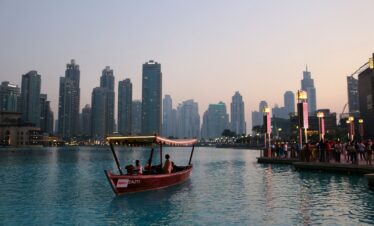 people riding on boat near dock