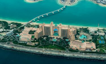 aerial photography of concrete buildings on the middle of the sea