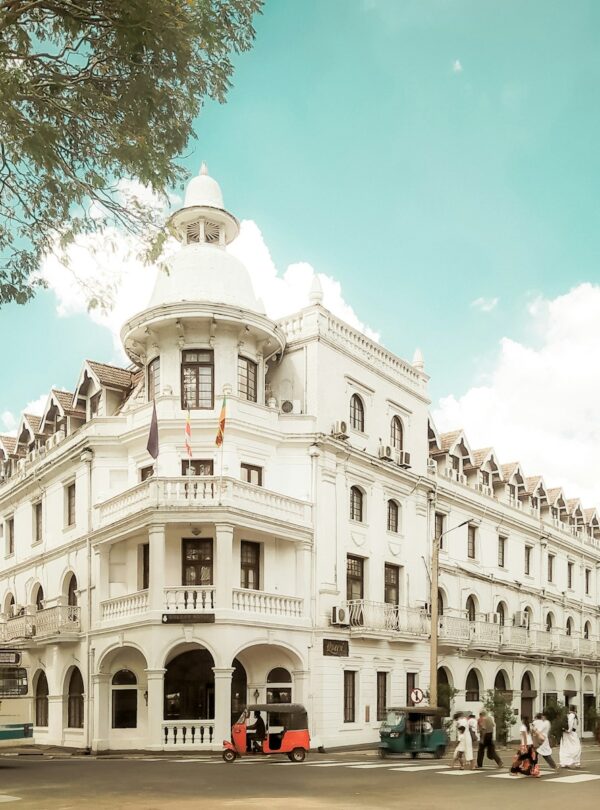 a large white building with a bus parked in front of it