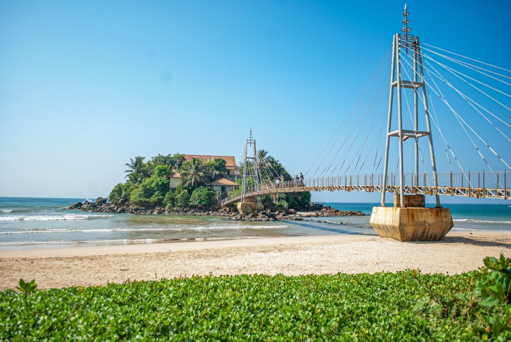 brown wooden bridge over the sea during daytime