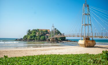 brown wooden bridge over the sea during daytime
