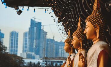 a row of buddha statues sitting next to each other