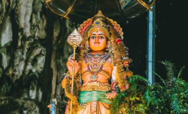 A statue of a person holding an umbrella