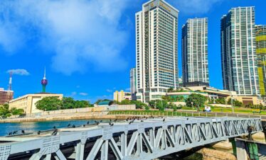 white bridge over river near city buildings during daytime