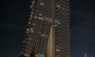 a very tall building with some statues in front of it