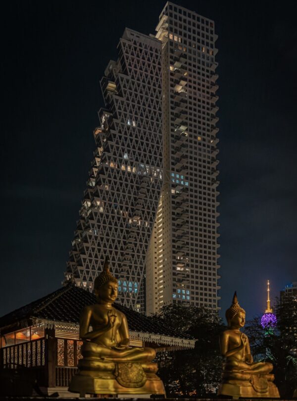 a very tall building with some statues in front of it