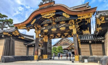 A large asian gate with a sky background