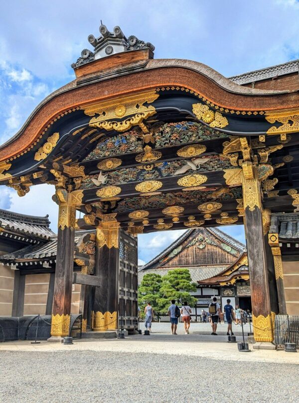 A large asian gate with a sky background