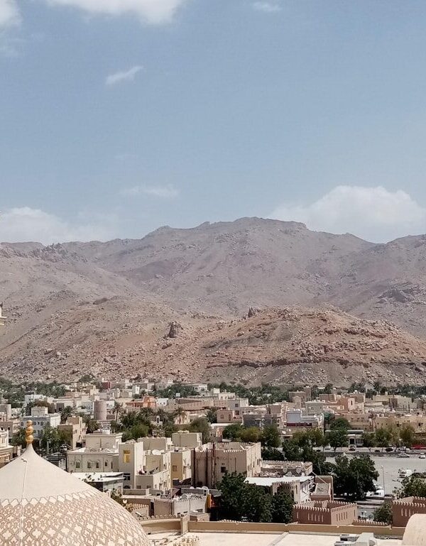 white concrete building near mountain during daytime
