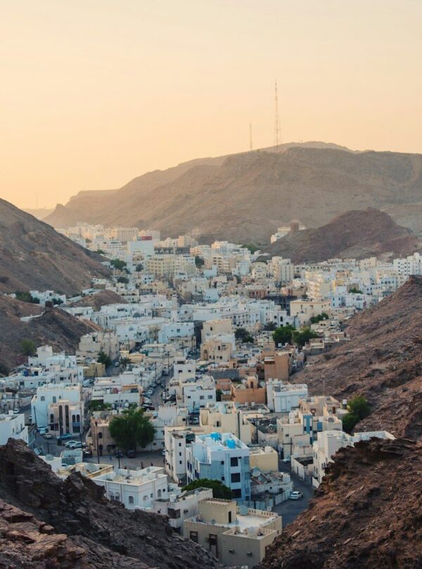 aerial view of white concrete buildings near rock cliffs