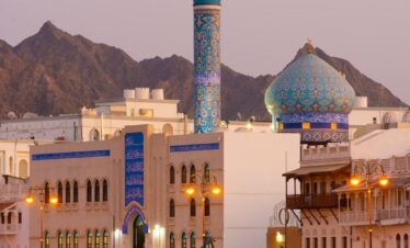 white concrete building near mountain during daytime