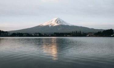 white and black mountain near body of water during daytime