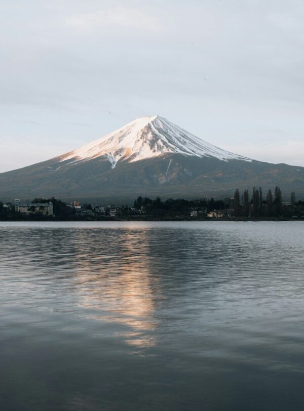 white and black mountain near body of water during daytime