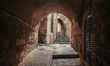 a narrow tunnel with steps leading up to it
