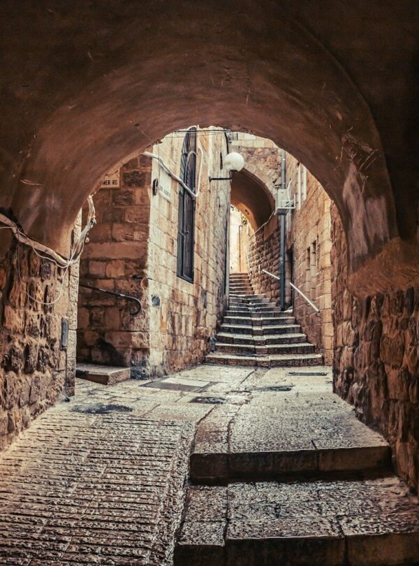a narrow tunnel with steps leading up to it