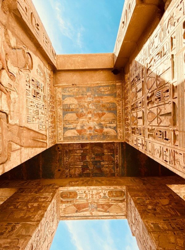 low angle photography of brown concrete building under blue sky during daytime