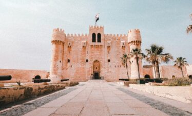 a castle like building with a flag on top of it