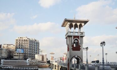 a bridge over water with buildings on the side