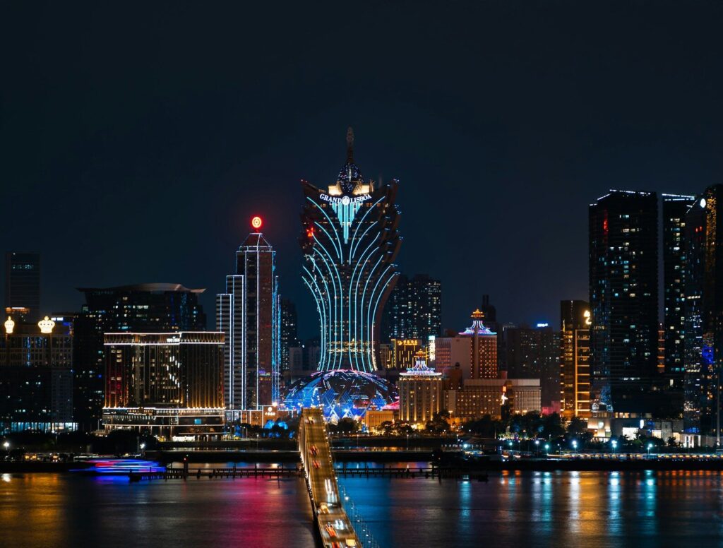 a city skyline at night with a bridge going across it