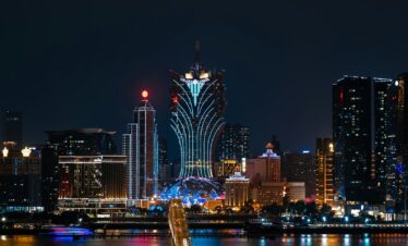 a city skyline at night with a bridge going across it