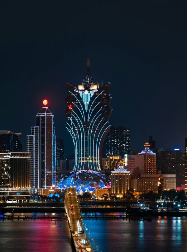 a city skyline at night with a bridge going across it