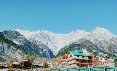 green wooden bridge over the mountains during daytime