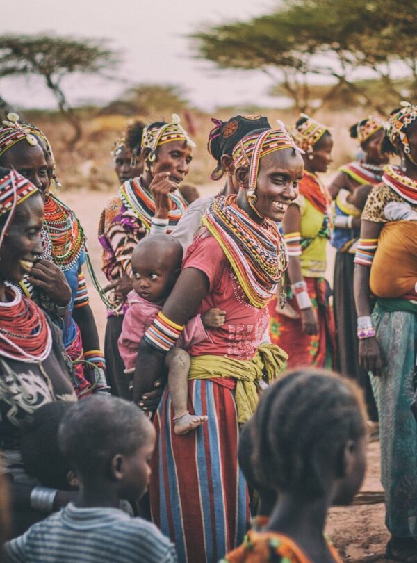group of people standing on brown ground