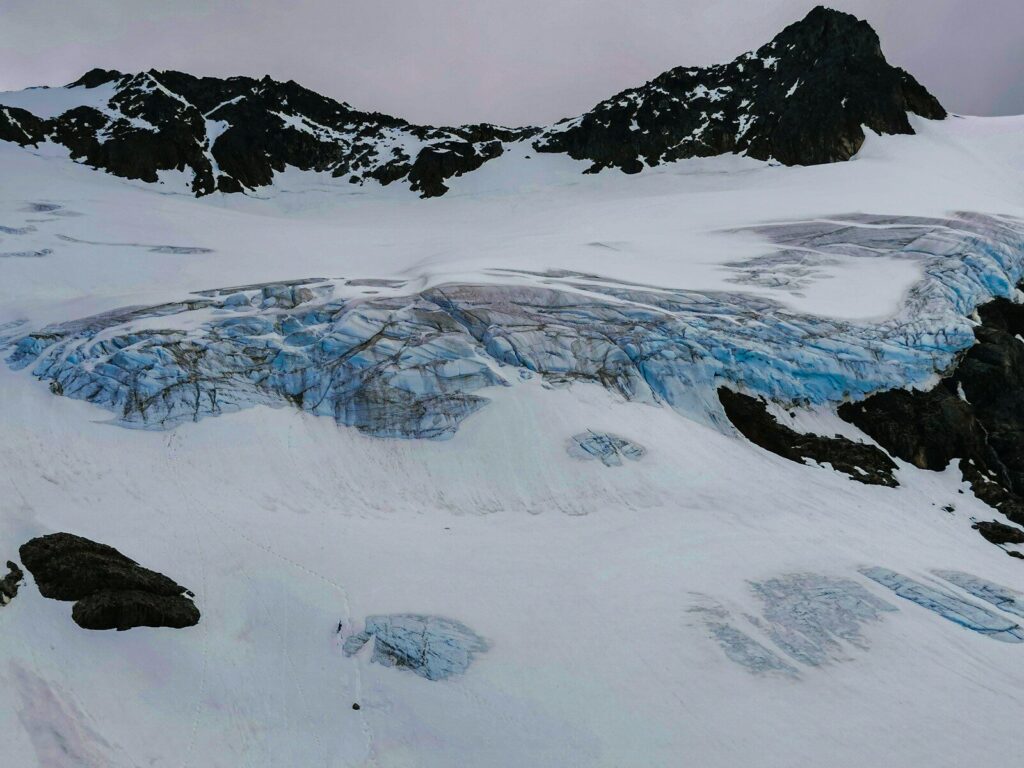 a snow covered mountain with a glacier in the background