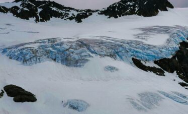 a snow covered mountain with a glacier in the background