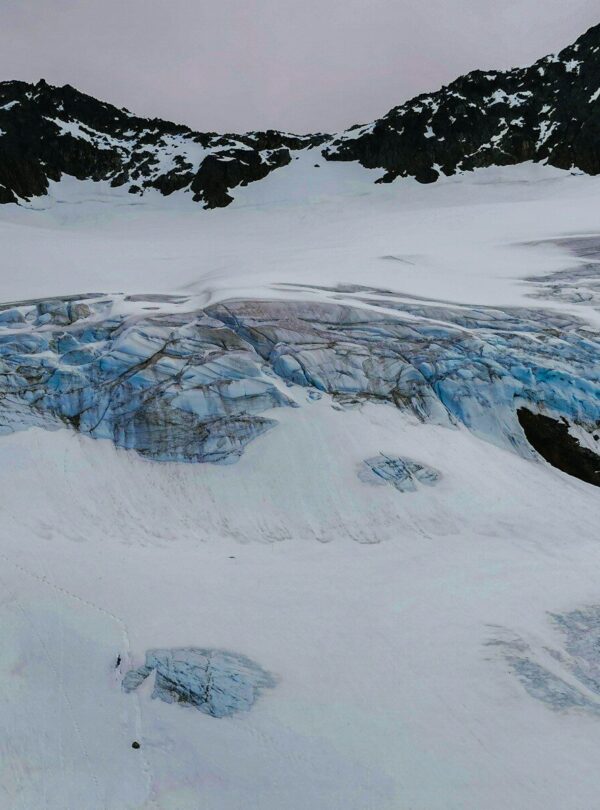 a snow covered mountain with a glacier in the background