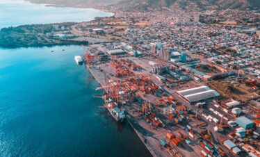 aerial view of city buildings near body of water during daytime