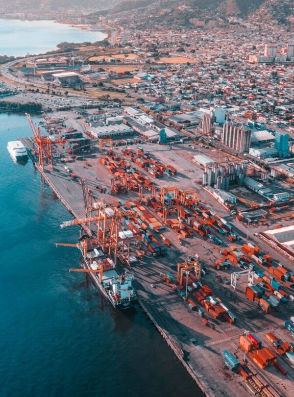 aerial view of city buildings near body of water during daytime