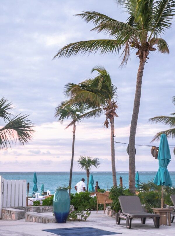 white wooden table and chairs near beach during daytime