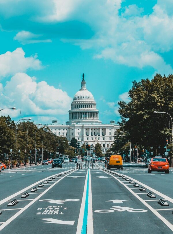 wide road with vehicle traveling with white dome building