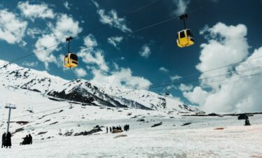 a ski lift going up a snowy mountain