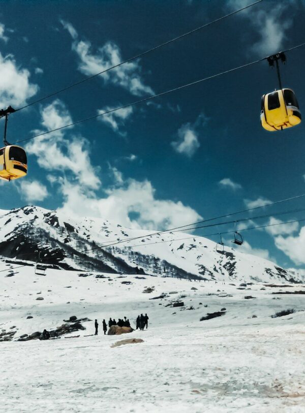 a ski lift going up a snowy mountain