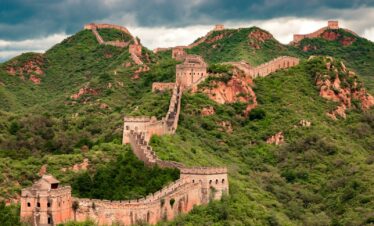 brown concrete building on top of hill