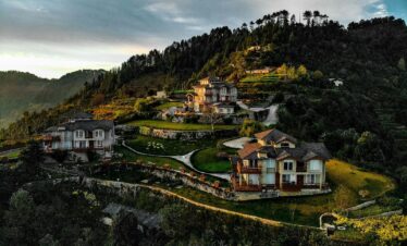 white and brown concrete house on hill