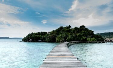 brown wooden dock on body of water during daytime