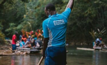 a person on a boat holding a paddle