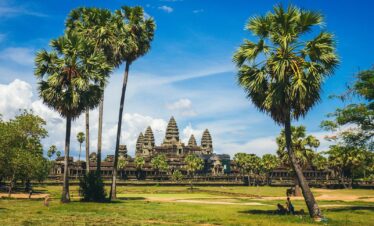 brown concrete building under white clouds