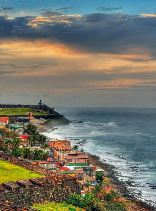 houses near sea under cloudy sky during daytime