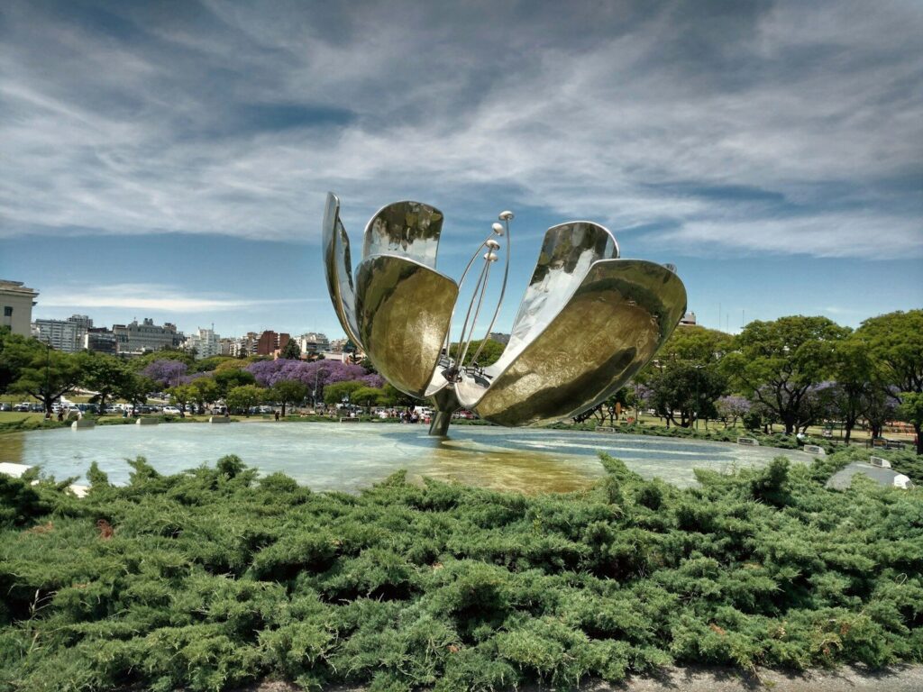 a large metal sculpture in the middle of a park