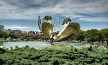 a large metal sculpture in the middle of a park