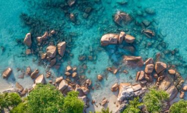 a body of water with rocks and trees around it