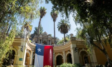 a large texas state flag hanging from the side of a building