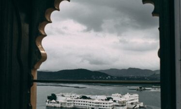 white and black ship on sea under white clouds during daytime