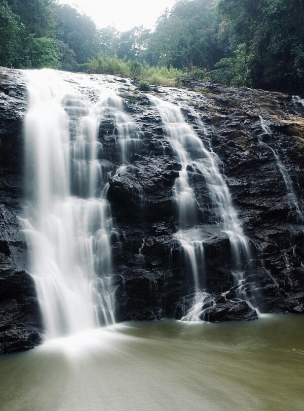 waterfalls on brown rocky mountain during daytime